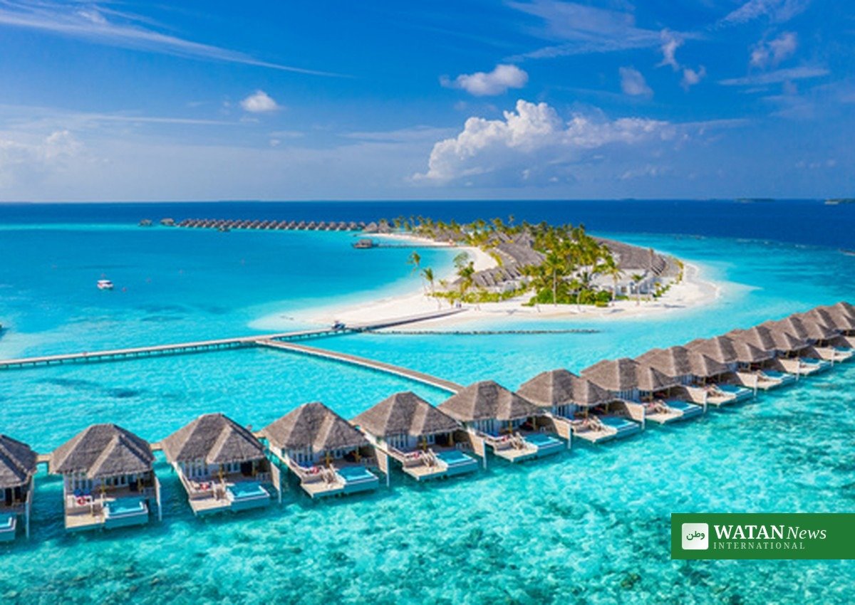 Overwater villas over a turquoise lagoon in the Maldives