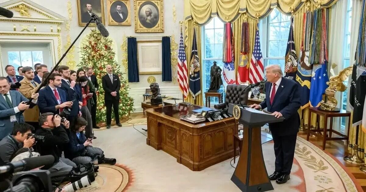 Donald Trump speaks at a podium in the Oval Office during a press briefing on Iran