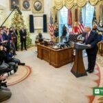 Donald Trump speaks at a podium in the Oval Office during a press briefing on Iran