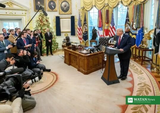 Donald Trump speaks at a podium in the Oval Office during a press briefing on Iran