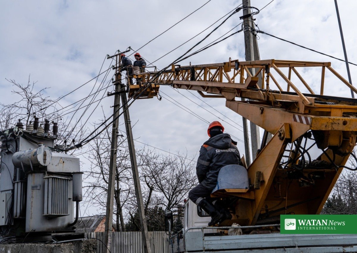 Ukrainian energy workers repairing power lines in the Kharkiv region