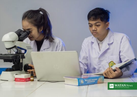 A scientist observing bacteria through a microscope in a laboratory