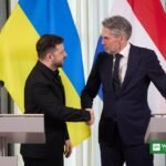 Ukrainian President Volodymyr Zelenskyy shaking hands at a meeting in The Hague; the Zelenskiy energy truce offer came on Sunday